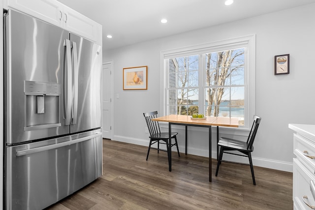 kitchen with recessed lighting, dark wood-type flooring, white cabinetry, baseboards, and stainless steel refrigerator with ice dispenser