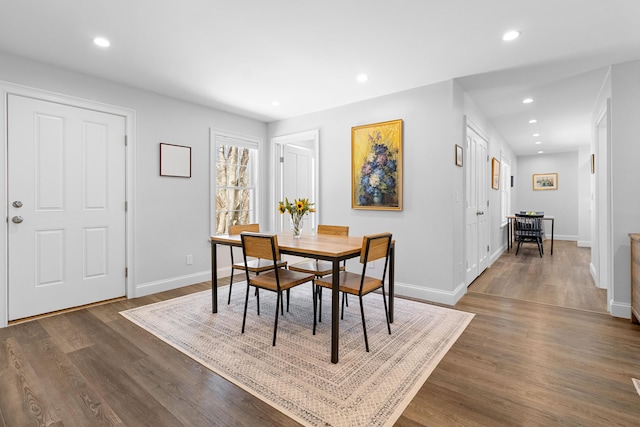 dining room featuring baseboards, dark wood-type flooring, and recessed lighting