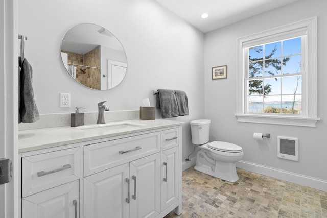 full bathroom featuring baseboards, a shower, toilet, heating unit, and vanity