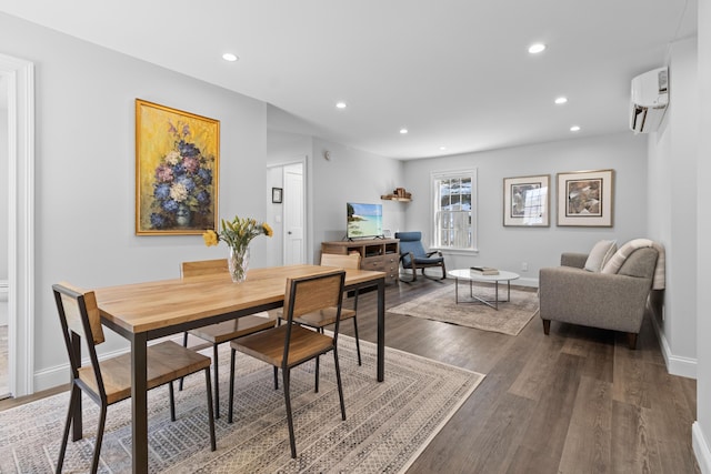 dining area with dark wood-style floors, recessed lighting, a wall mounted air conditioner, and baseboards