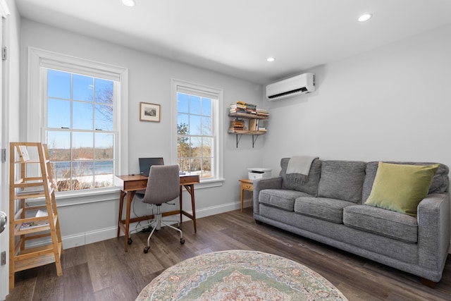 office space featuring a wall unit AC, a wealth of natural light, and baseboards