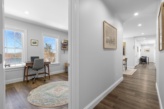 corridor with dark wood-style floors, recessed lighting, and baseboards