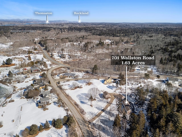 snowy aerial view featuring a mountain view