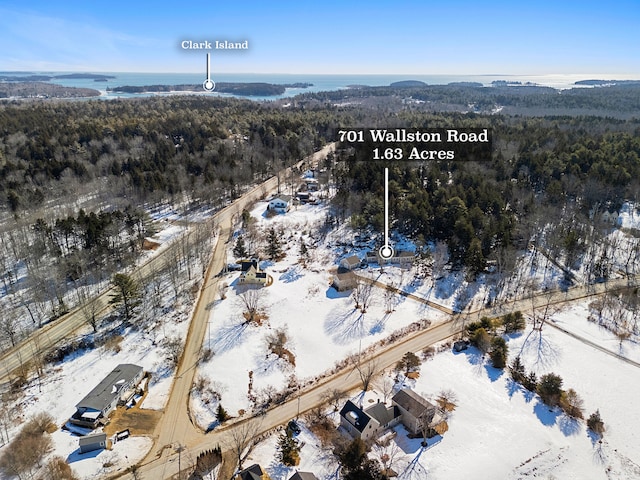 snowy aerial view featuring a view of trees