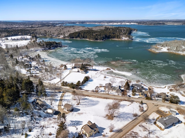 snowy aerial view featuring a water view