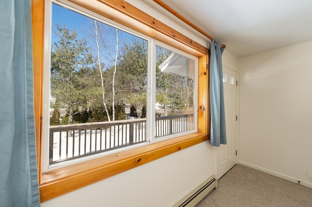 empty room with baseboards, a textured ceiling, carpet, and a healthy amount of sunlight