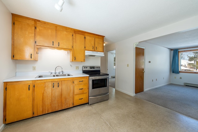 kitchen featuring baseboards, light countertops, stainless steel range with electric cooktop, under cabinet range hood, and a sink