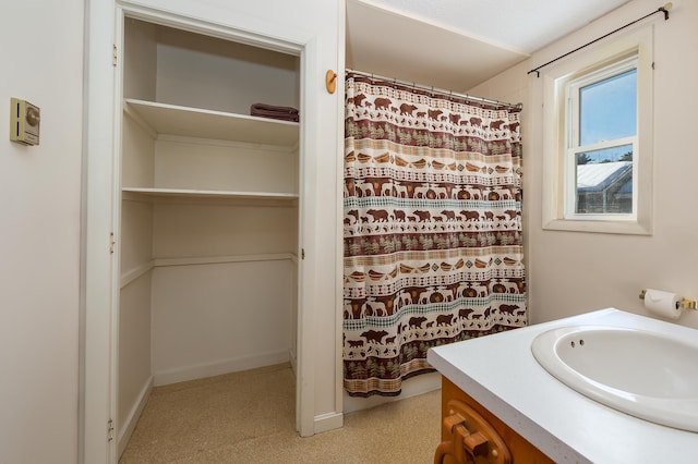 bathroom with a shower with shower curtain and vanity