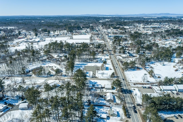 snowy aerial view featuring a mountain view