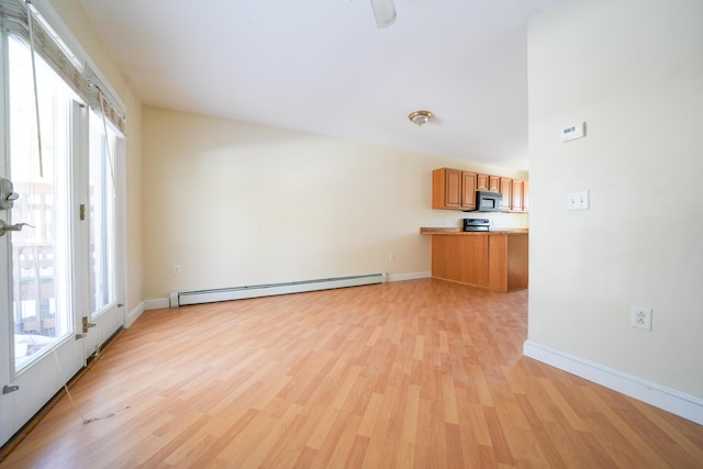 unfurnished living room featuring light wood-type flooring, baseboards, and a baseboard heating unit