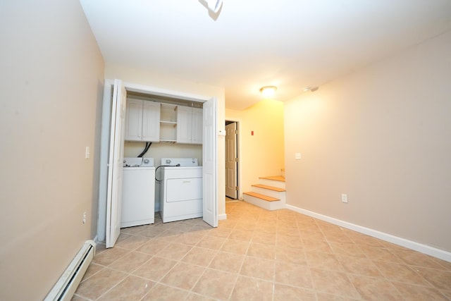 interior space with a baseboard radiator, cabinet space, washer and clothes dryer, and baseboards