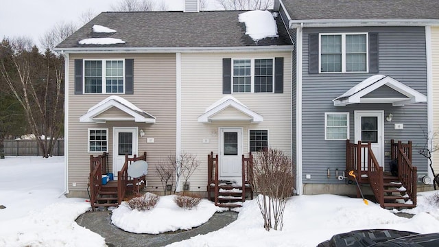 view of front of house featuring a shingled roof and a chimney