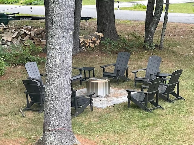 view of yard featuring a fire pit and a patio