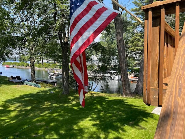 view of yard with a boat dock and a water view