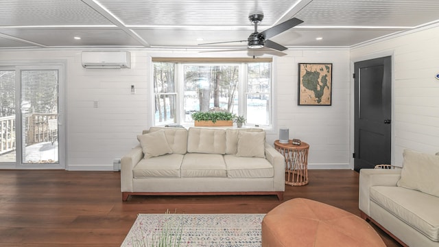 living room with a ceiling fan, wood finished floors, a wall mounted air conditioner, coffered ceiling, and baseboards