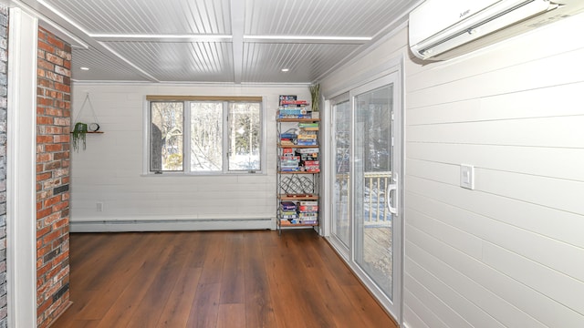 interior space with a baseboard heating unit and a wall mounted air conditioner