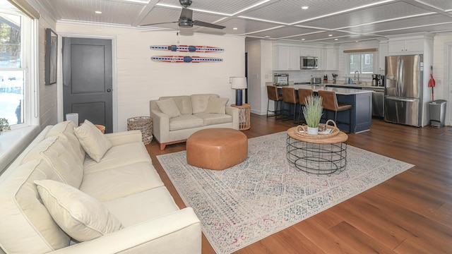 living area featuring ceiling fan, dark wood-style flooring, coffered ceiling, and recessed lighting