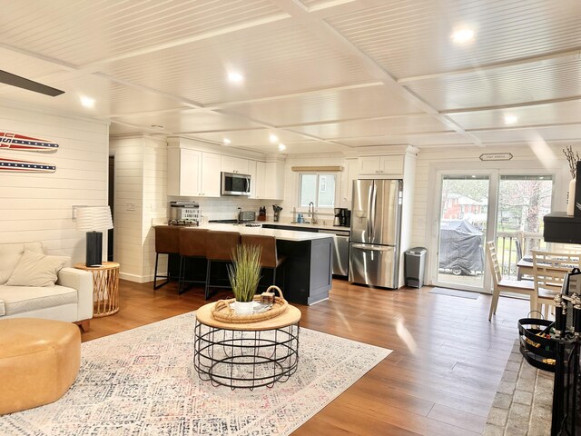 7 Birch Dr, Raymond, ME 04071 - living area featuring coffered ceiling, recessed lighting, wood finished floors, and plenty of natural light