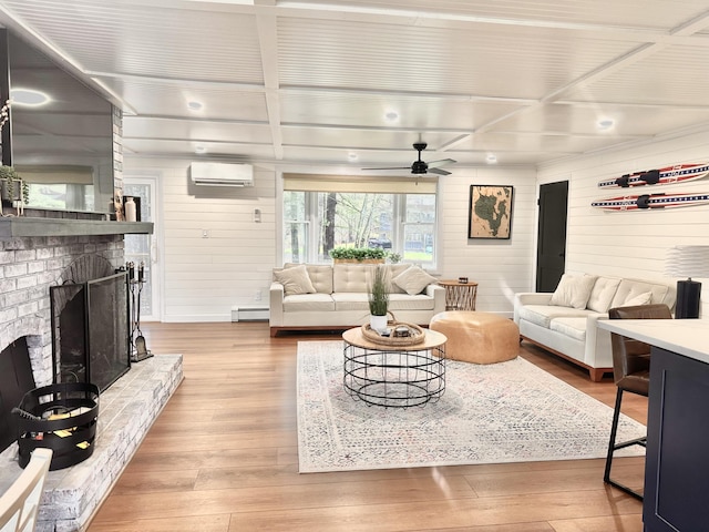 7 Birch Dr, Raymond, ME 04071 - living room with a baseboard heating unit, light wood-style floors, a wall unit AC, a ceiling fan, and wooden walls