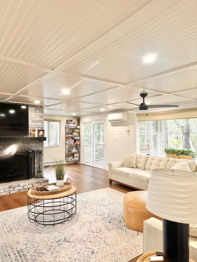 7 Birch Dr, Raymond, ME 04071 - living area featuring wood ceiling, an AC wall unit, a brick fireplace, wood finished floors, and a ceiling fan