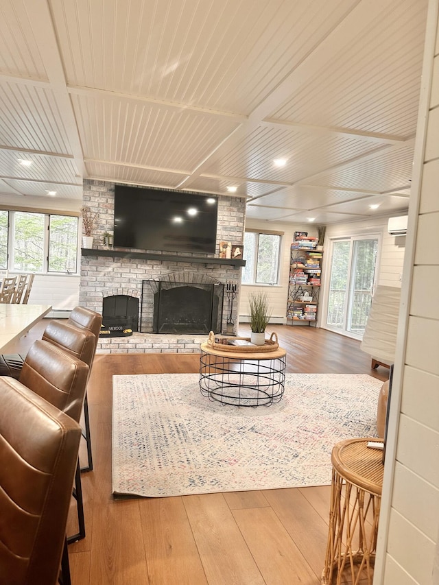 7 Birch Dr, Raymond, ME 04071 - living room with wood ceiling, hardwood / wood-style floors, a wall mounted air conditioner, and a brick fireplace
