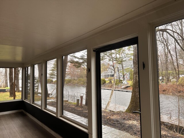 7 Birch Dr, Raymond, ME 04071 - unfurnished sunroom with a water view, baseboards, wood finished floors, and a healthy amount of sunlight