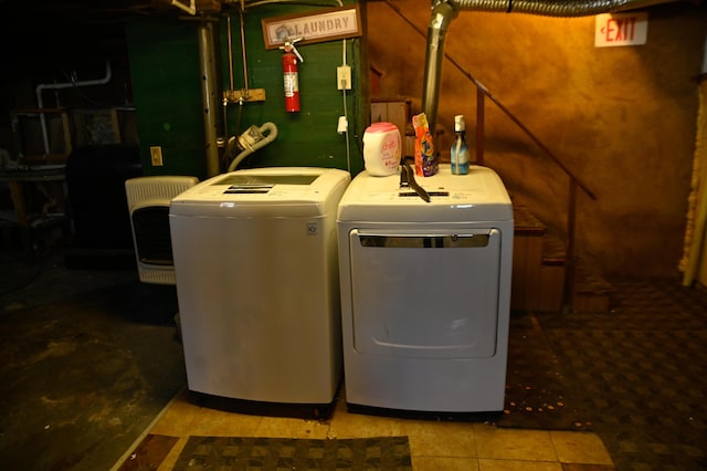 clothes washing area featuring laundry area and washer and clothes dryer