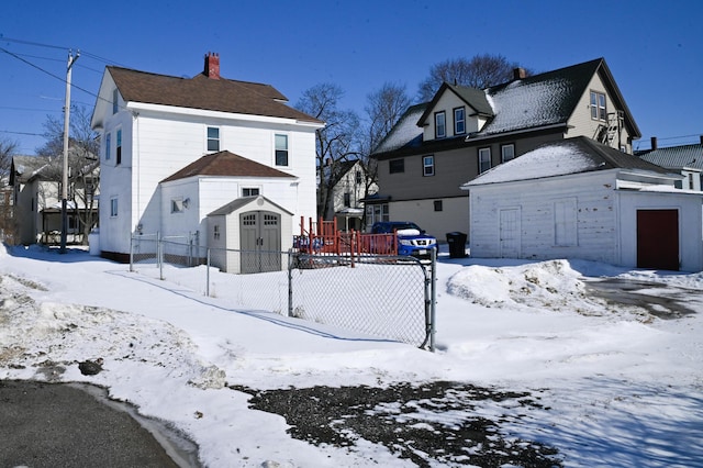 exterior space featuring a chimney and fence