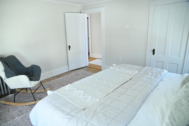 bedroom with baseboards and wood finished floors