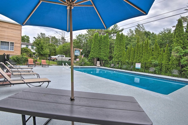 pool featuring a patio and fence