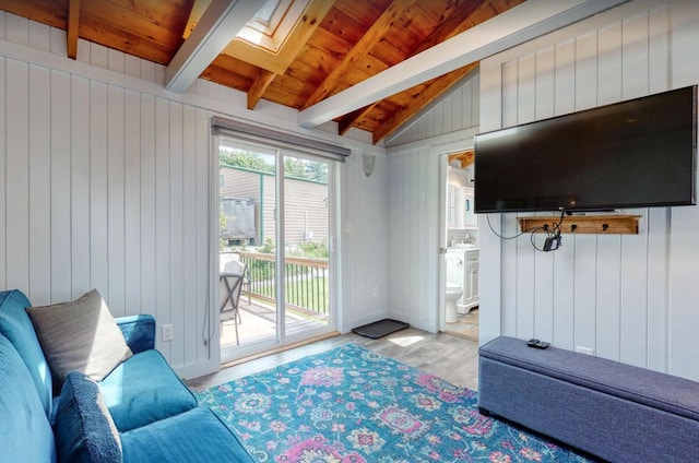 interior space with lofted ceiling with skylight, wooden ceiling, baseboards, and wood finished floors