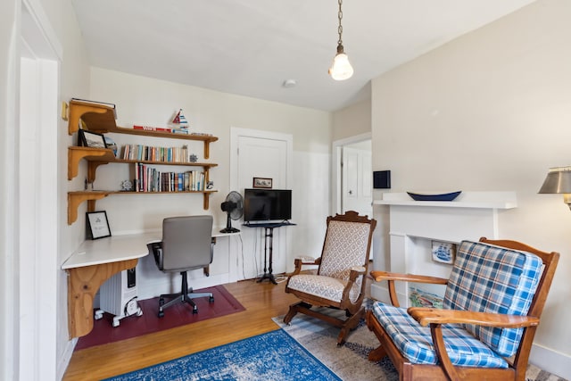 office with wood finished floors and built in desk