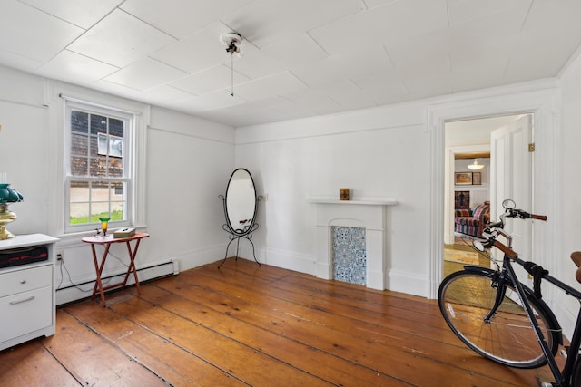 miscellaneous room with light wood-type flooring and a baseboard radiator