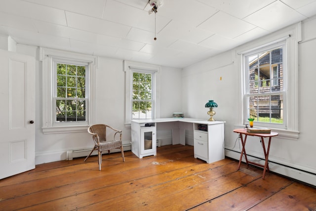 office space with light wood-type flooring and baseboard heating