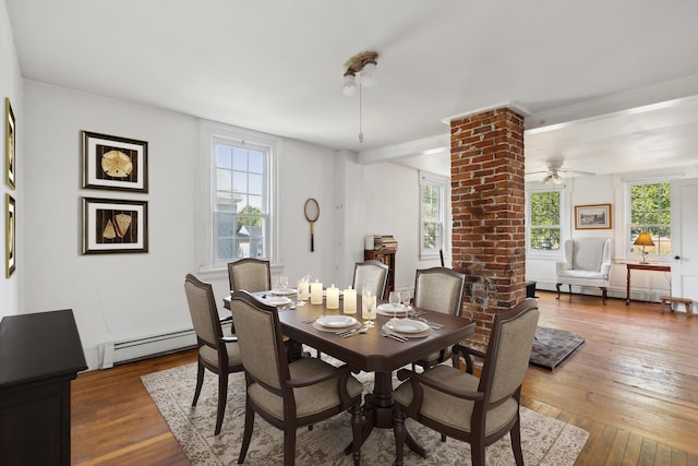 dining area featuring a baseboard radiator, hardwood / wood-style floors, and a ceiling fan