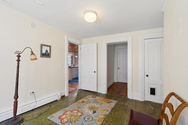 interior space with granite finish floor, baseboard heating, and baseboards