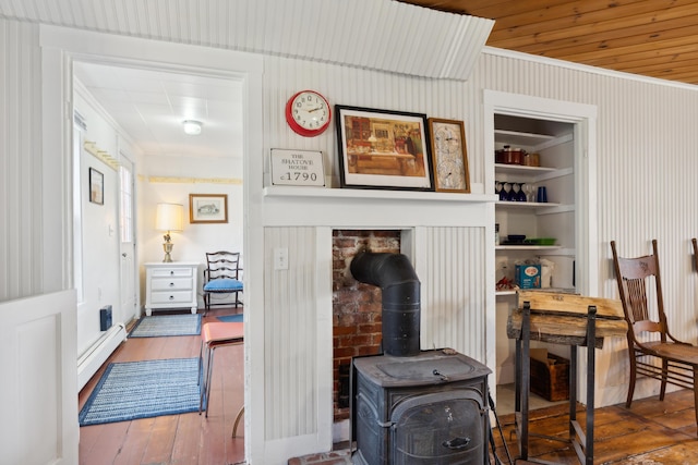 interior space featuring wood finished floors, crown molding, and a baseboard radiator