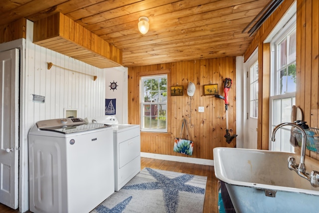 laundry room featuring washer and clothes dryer, laundry area, wood ceiling, and a sink