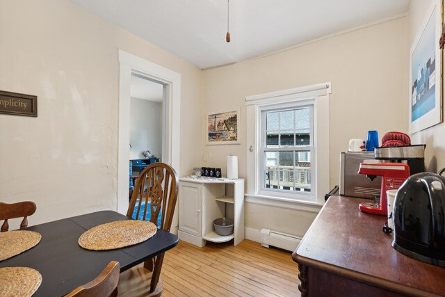 dining room featuring light wood-style flooring and baseboard heating