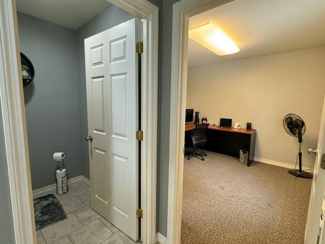 interior space featuring tile patterned flooring and baseboards