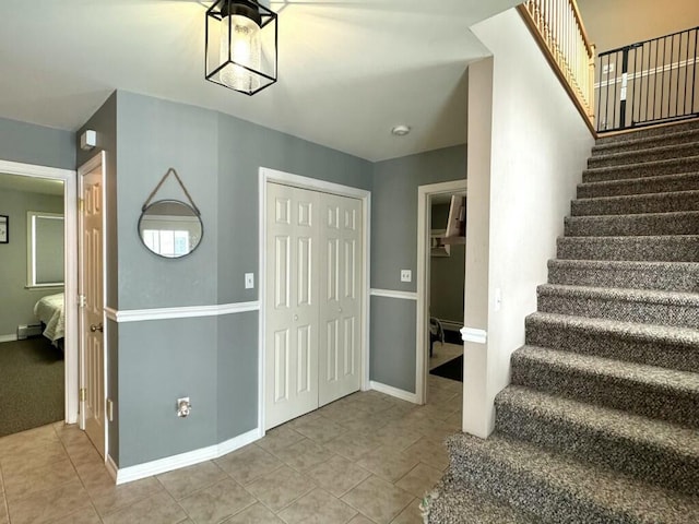 stairway with tile patterned flooring and baseboards