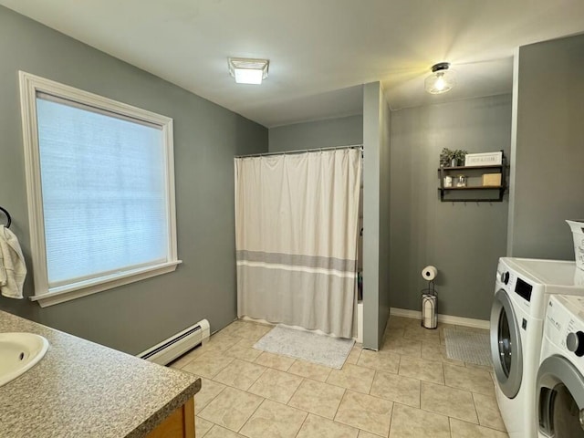 bathroom with curtained shower, a baseboard heating unit, vanity, tile patterned floors, and washing machine and clothes dryer