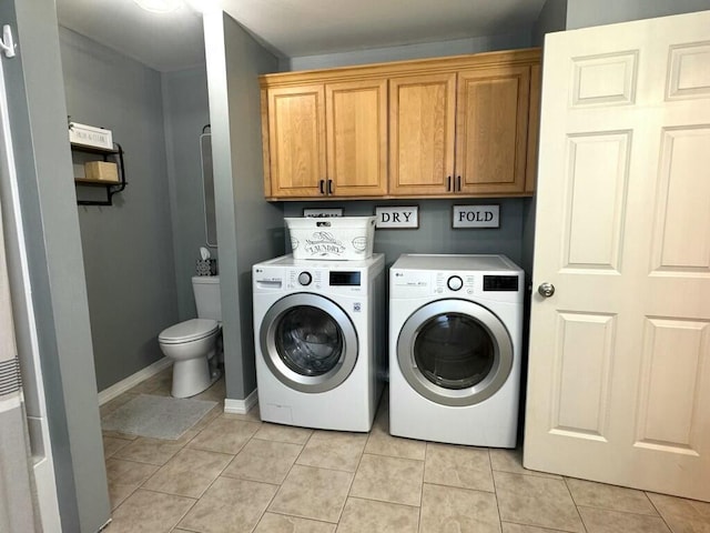 laundry area featuring light tile patterned floors, laundry area, baseboards, and separate washer and dryer