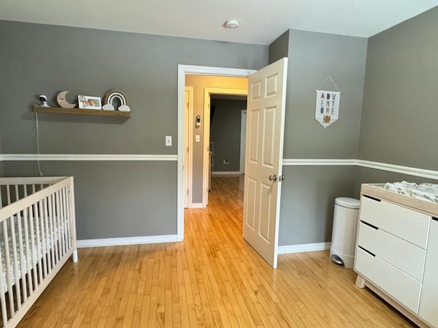 unfurnished bedroom featuring light wood-type flooring and baseboards