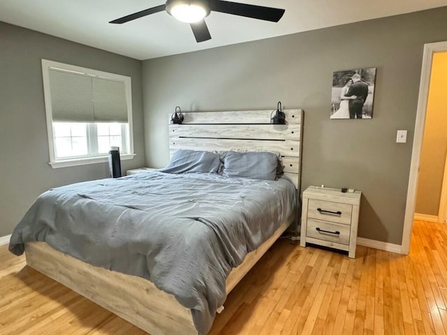 bedroom with wood-type flooring, baseboards, and ceiling fan