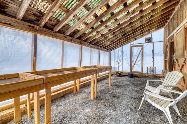 unfurnished sunroom featuring lofted ceiling