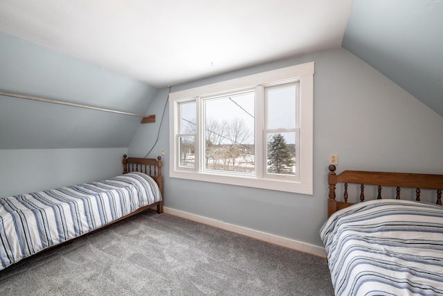 carpeted bedroom with lofted ceiling and baseboards