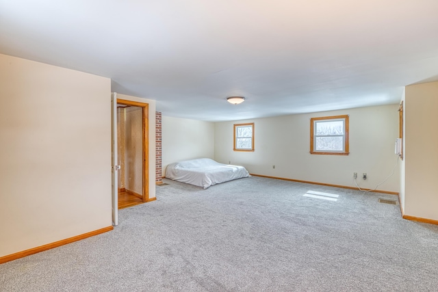 unfurnished bedroom with carpet flooring and baseboards