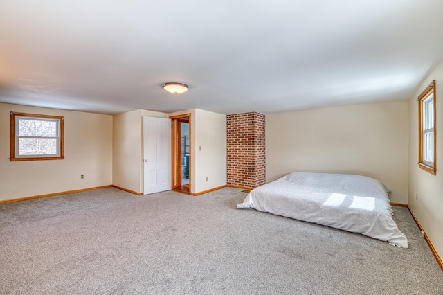 bedroom with light carpet and baseboards