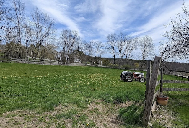 view of yard featuring fence and a rural view